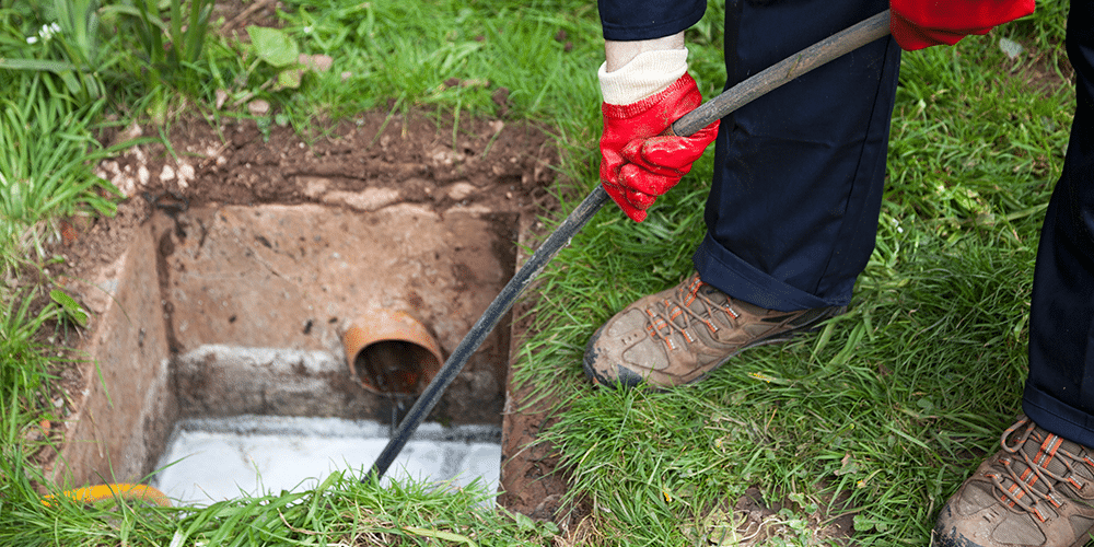Plumbing specialist uses a high-tech camera to inspect a sewer line.