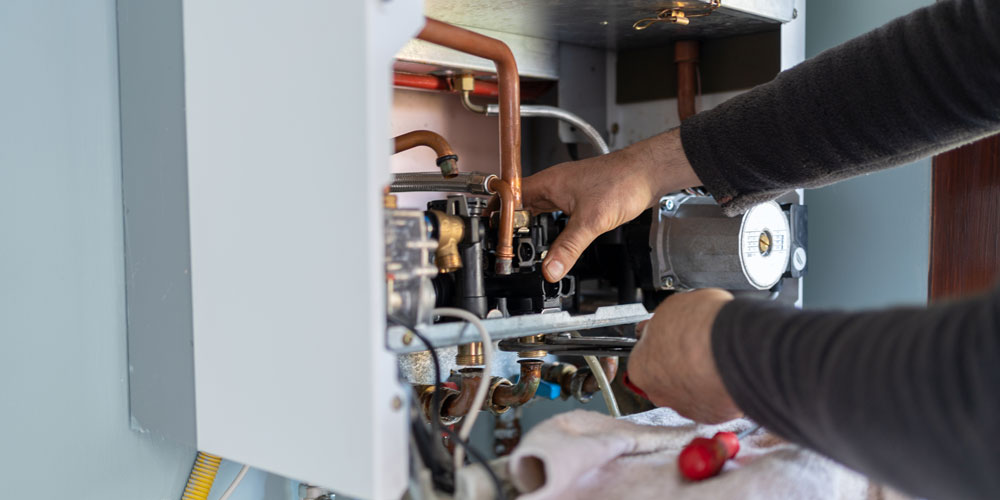 Expert furnance technician repairing gas boiler.