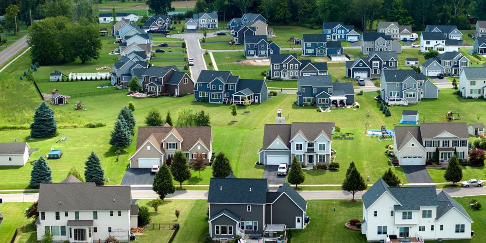 Aerial shot of a residential neighborhood with several large, two-story homes.